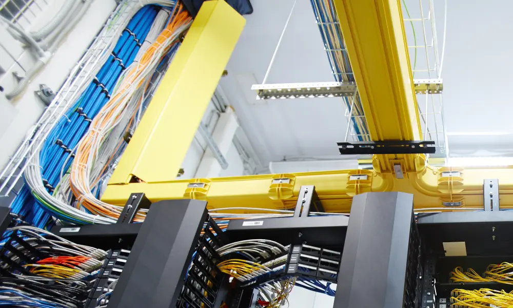 Cables in data center being routed in cable trays